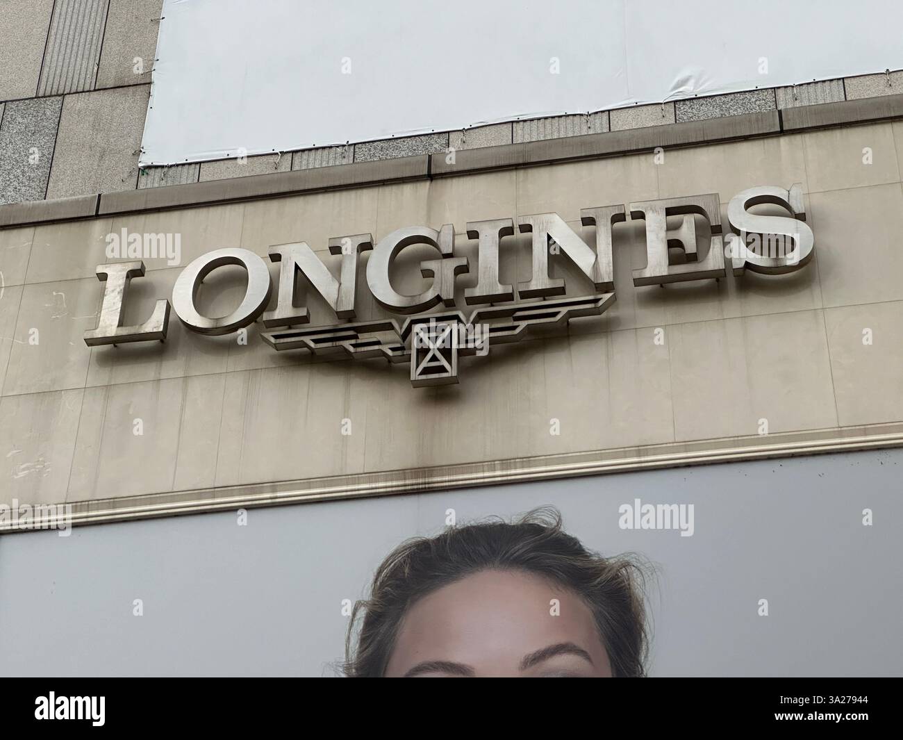Nanning, China - Nov 23, 2023: Longines logo on the wall. Longines is a Swiss luxury watchmaker. - Smartphone Captured Stock Image