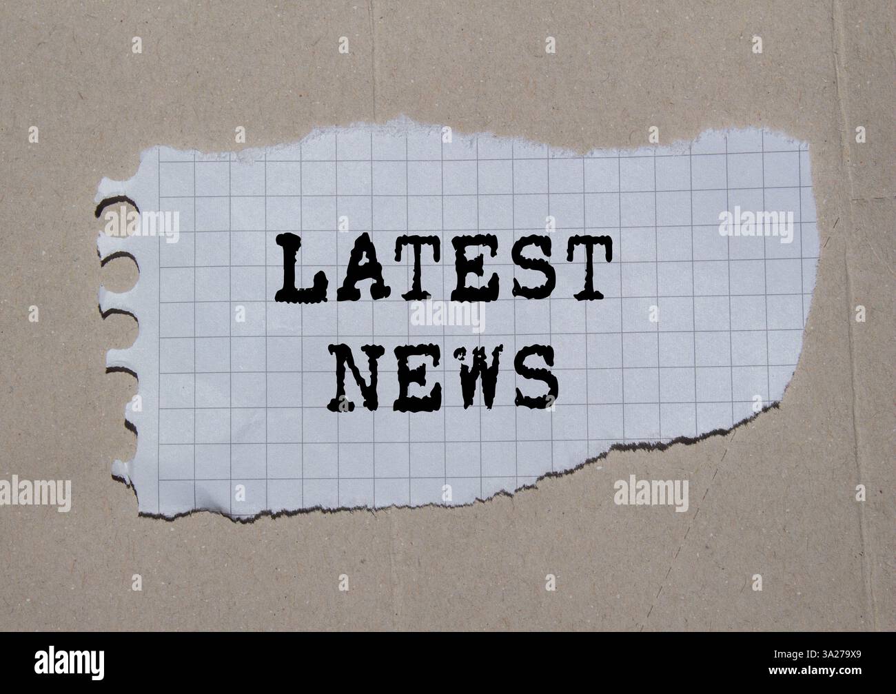 Latest news message written on ripped torn paper piece on paper ...