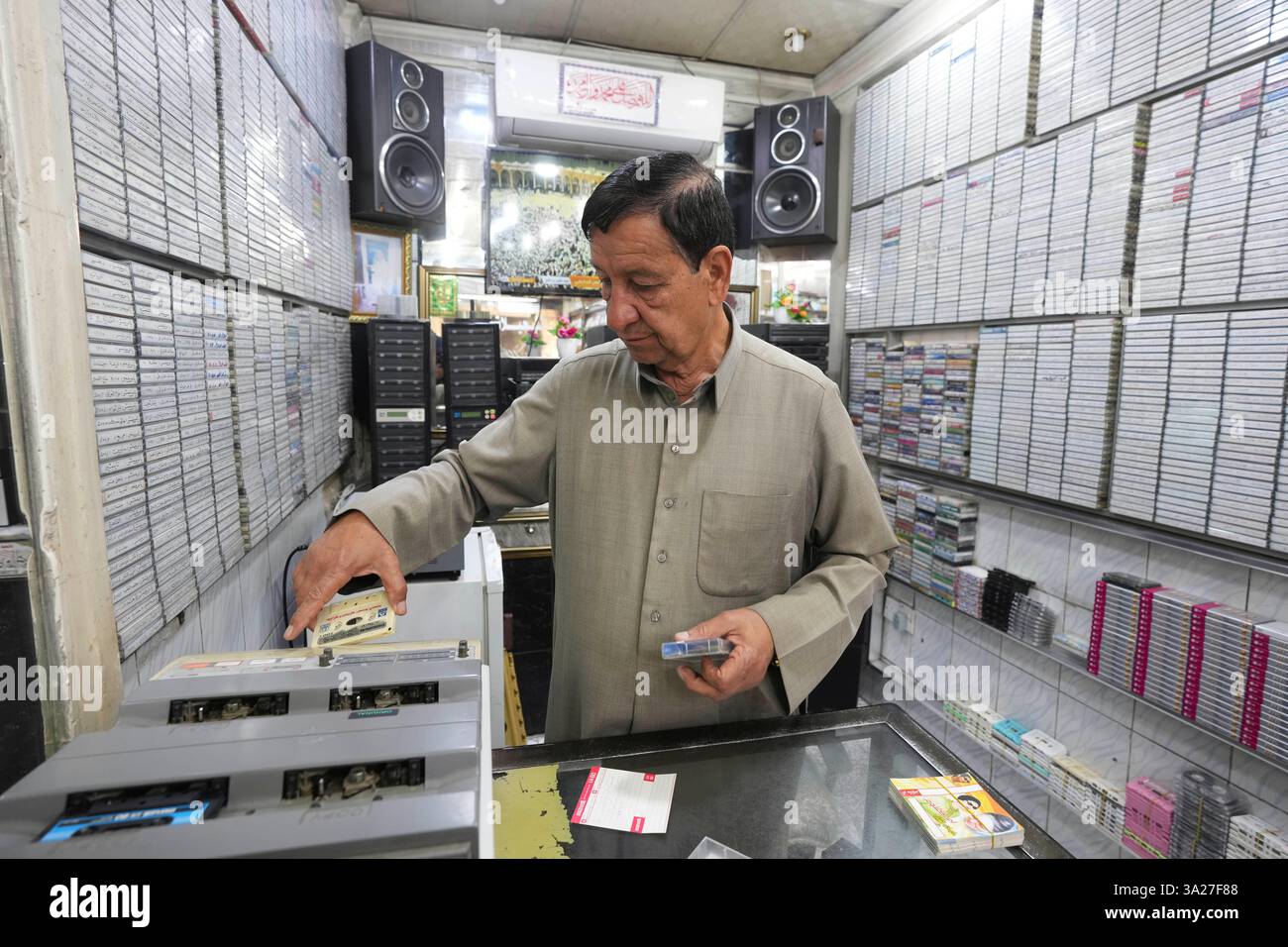 Abo Haidar, 65 years old plays one of the music cassette tapes that are