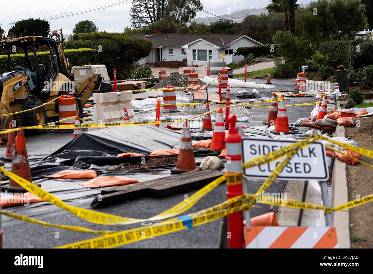 FILE - Caution tape closes off streets due to land movement intensified ...