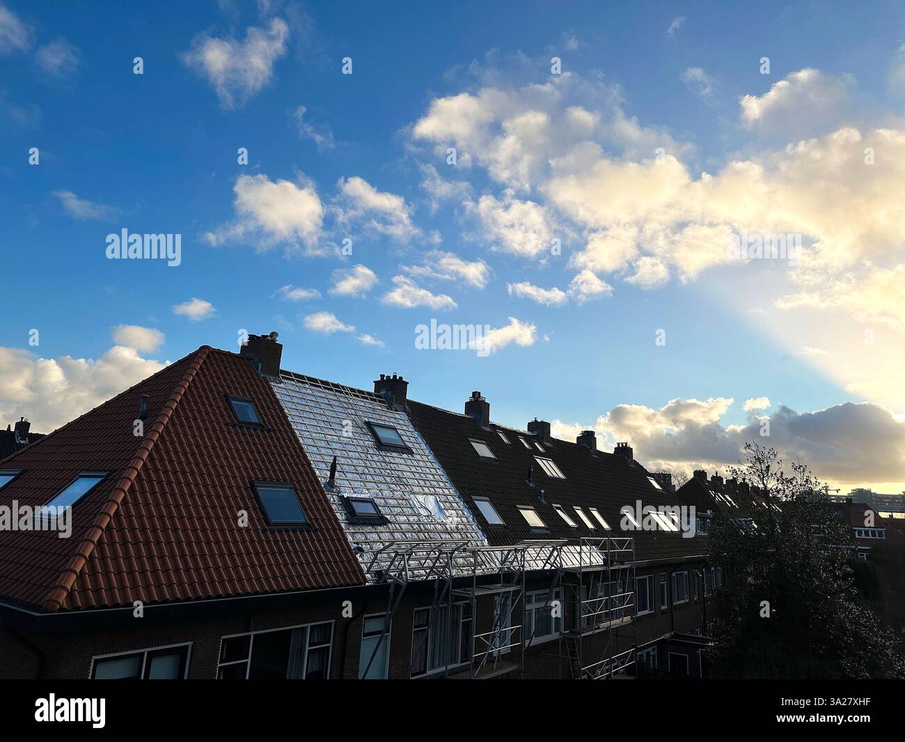 Residential building with roof renovation under blue sky Stock Photo ...