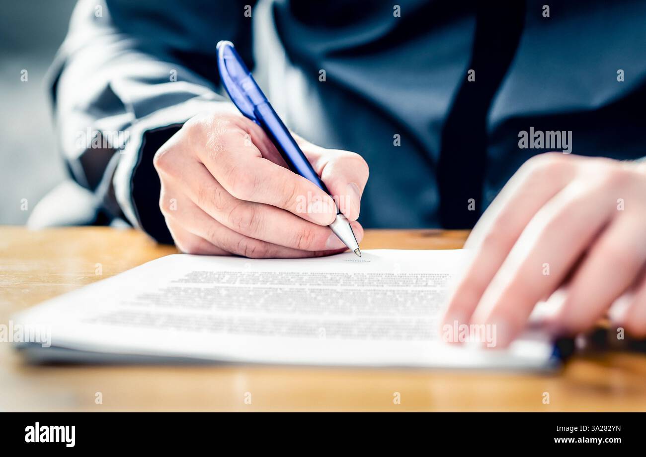 Settlement signature. Acquisition or buyout. Man signing insurance document. Car loan, lease or rental paper contract. Merger or business offer deed. Stock Photo