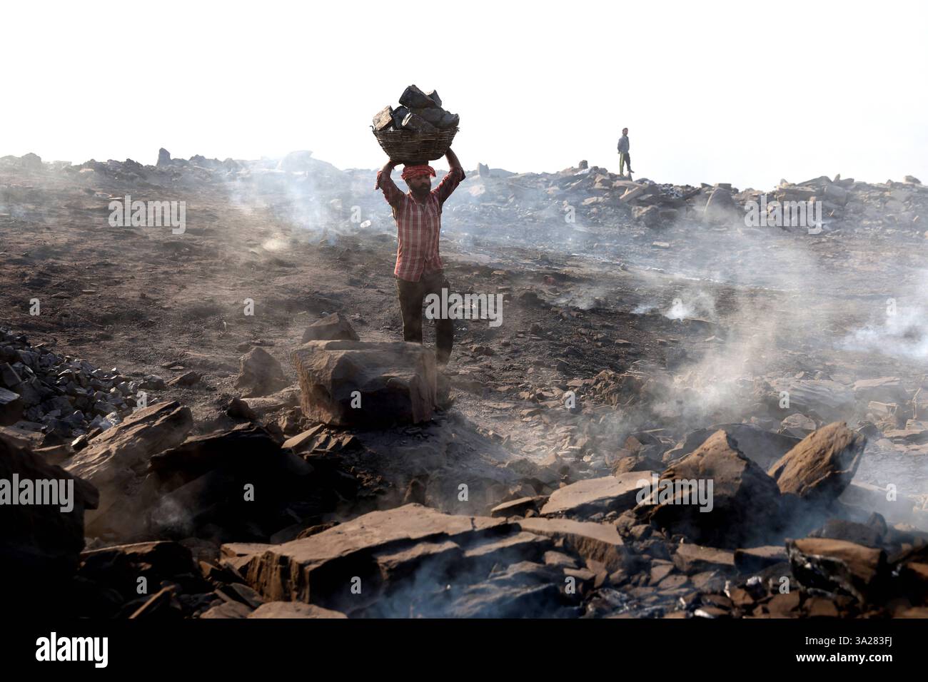 Coal mines of Jharkhand, India A coal scavenger carries a basket of ...