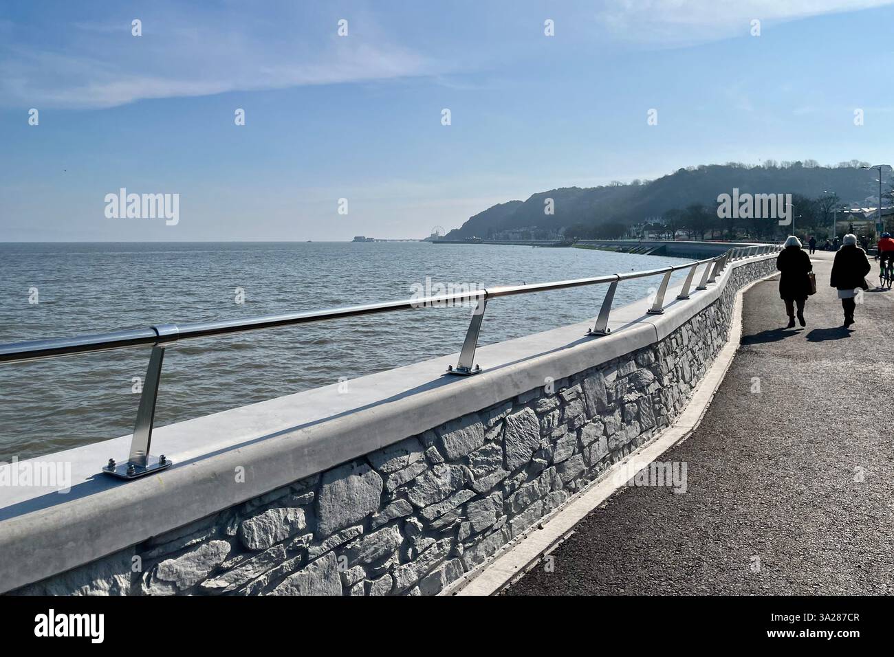 Looking towards Mumbles Pier from the Mumbles Prom, which was recently refurbished as part of the Mumbles Coastal Protection Scheme. 5th March 2025. - Smartphone Captured Stock Image