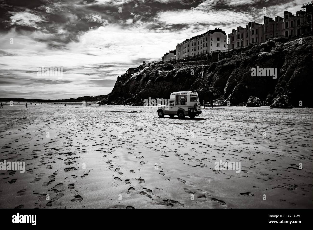 Selling ice cream on a deserted beach in Tenby Wales Stock Photo