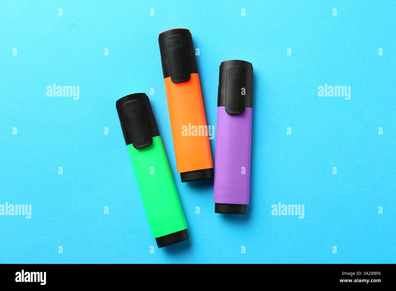 Bright highlighters on light blue background, flat lay Stock Photo