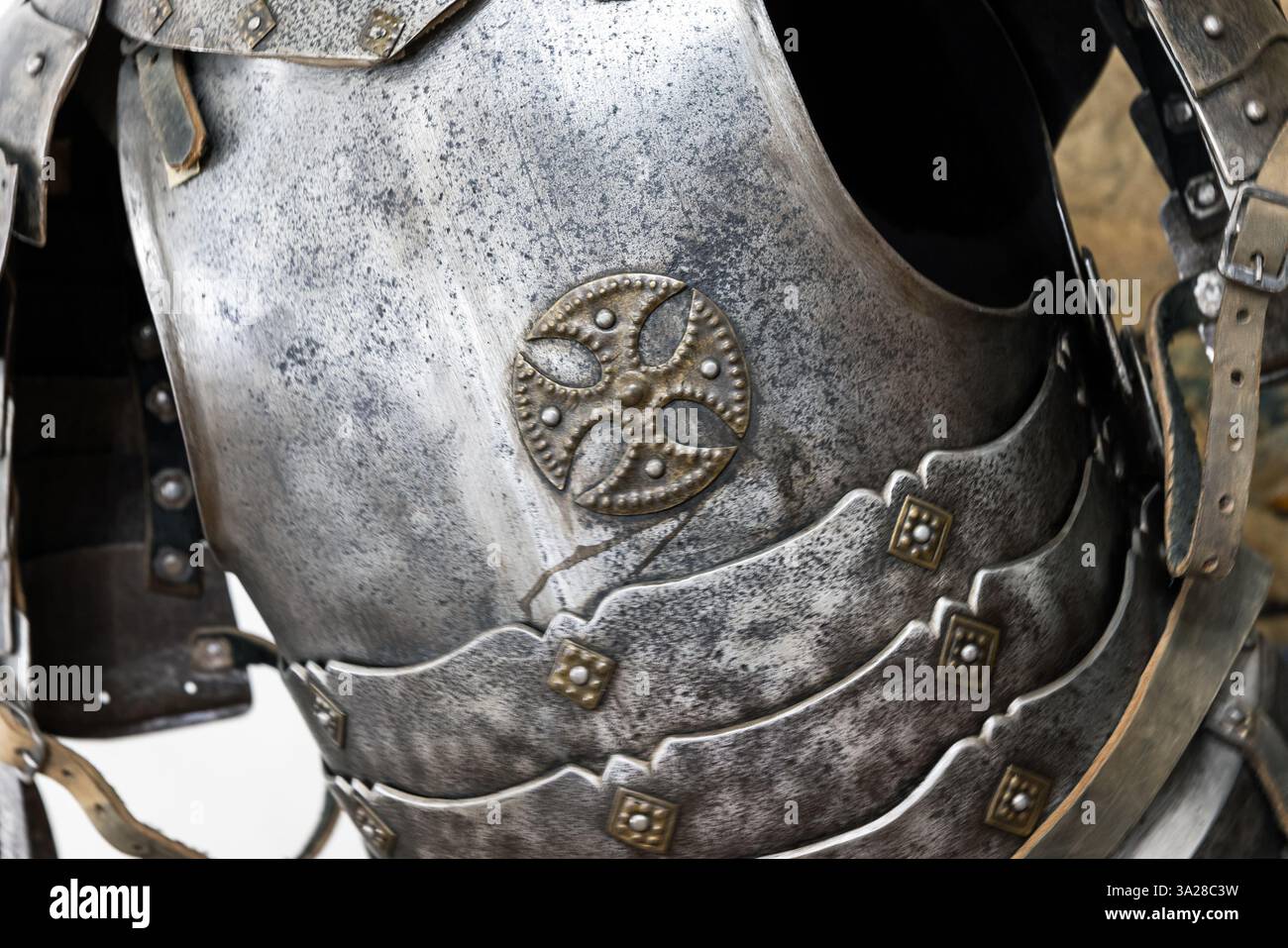 Detailed view of historical armor depicting craftsmanship with an ornate cross design, showcasing medieval artistry and functionality Stock Photo