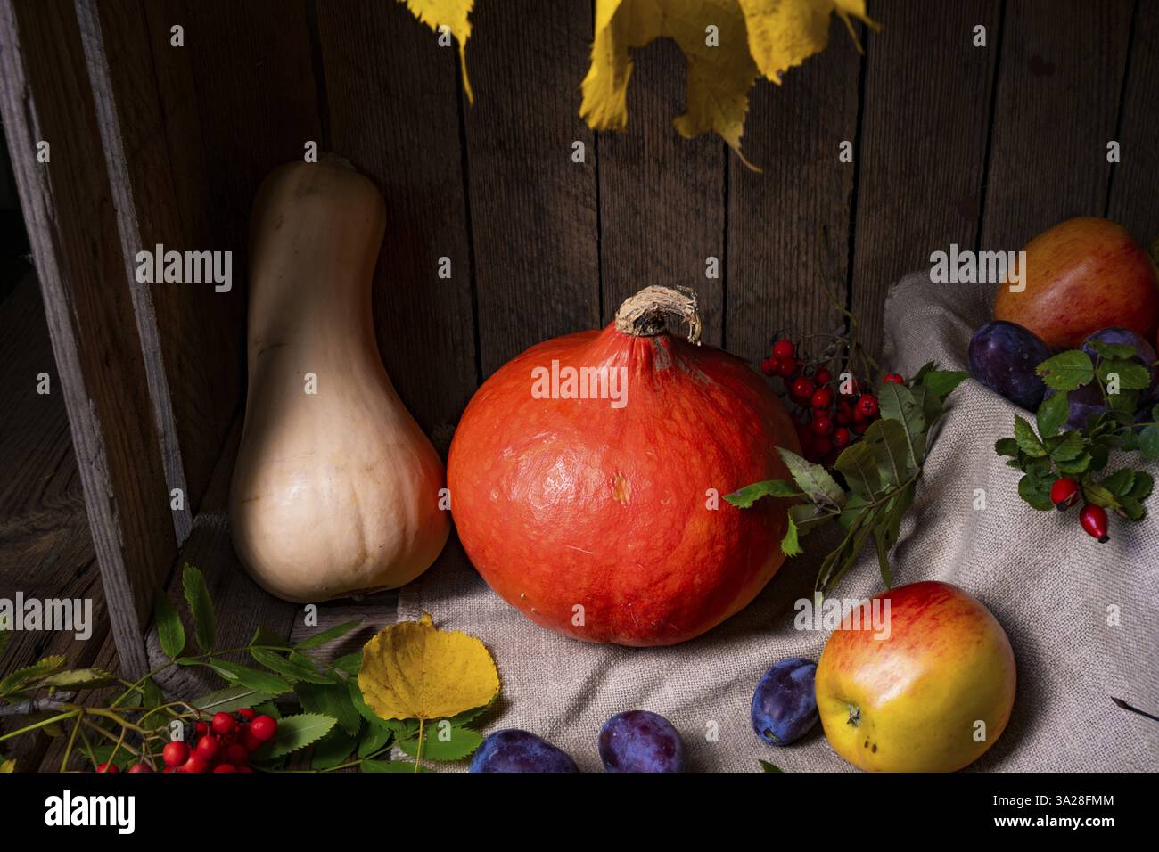 Various fruits in a wooden box with autumn leaves Stock Photo - Alamy