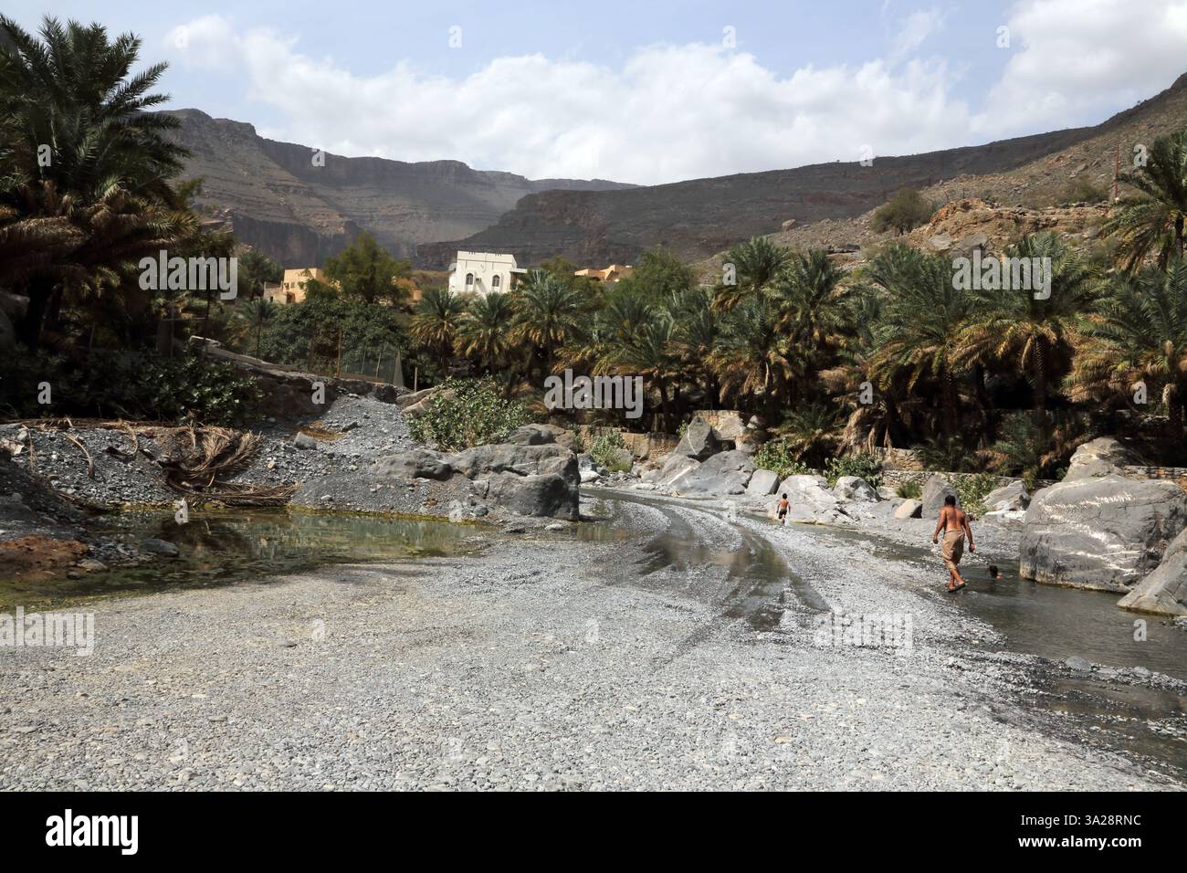 Father and Son in Wadi Ghul Hajar Mountains Al Hamra Oman Stock Photo