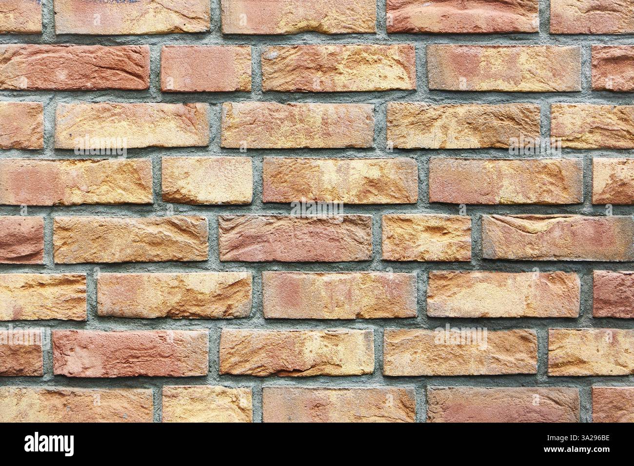 Colored red orange brick wall background Stock Photo