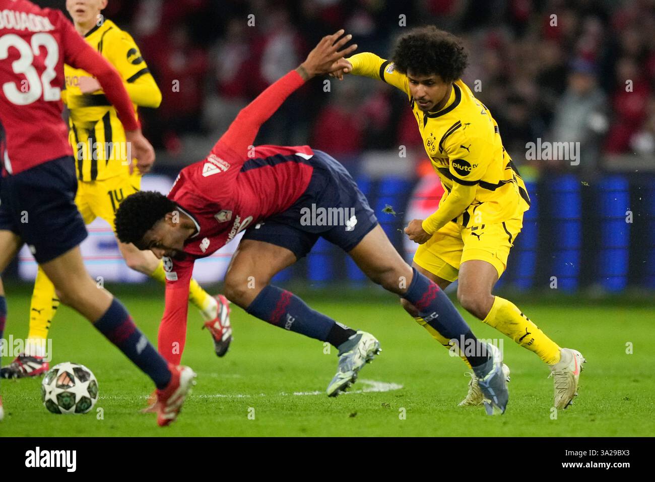 Lille's Alexsandro Ribeiro stumbles in front of Dortmund's Karim ...