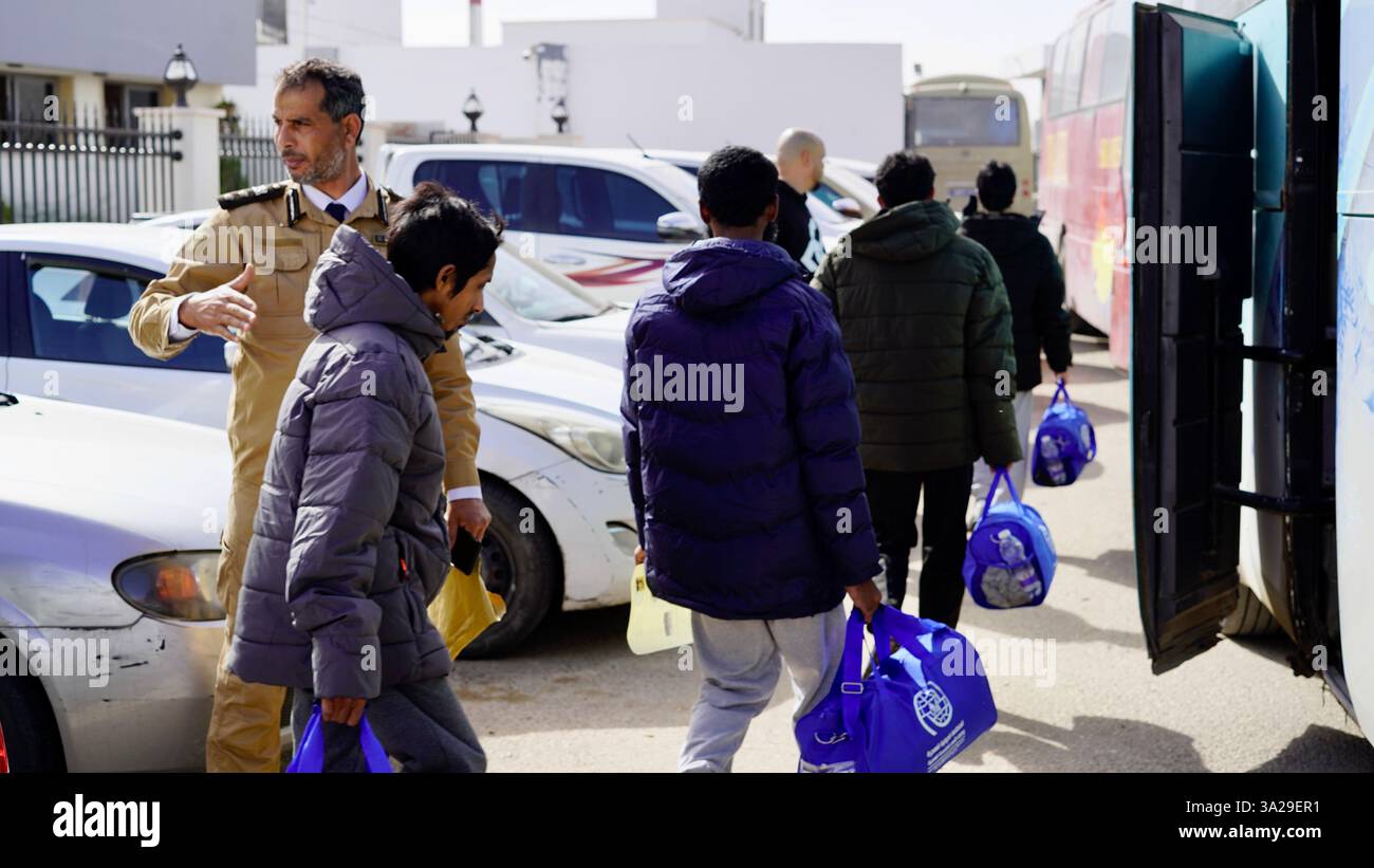 (250312) -- TRIPOLI, March 12, 2025 (Xinhua) -- Migrants line up to get