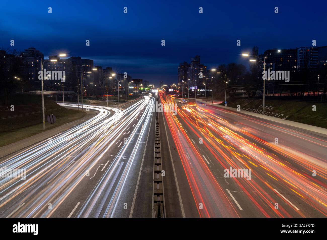 Long exposure of evening traffic on Highway M07 in Kyiv, Ukraine. The ...