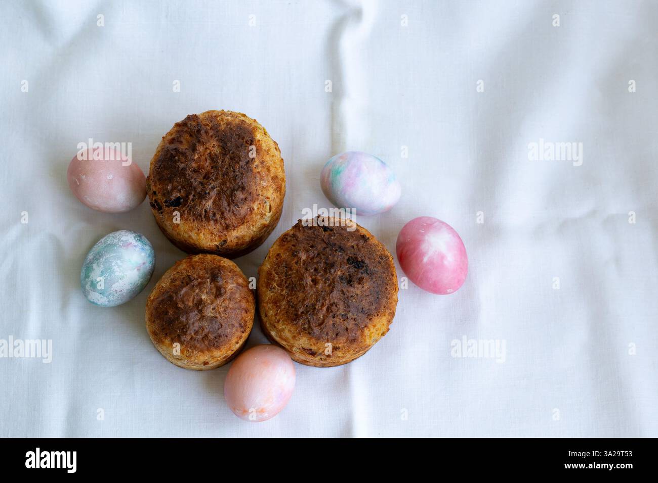 three whole wheat Easter cakes and Easter eggs, top view Stock Photo
