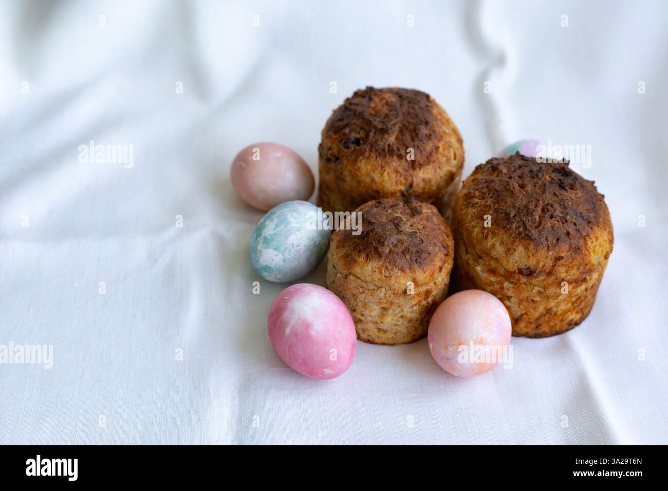 three whole wheat Easter cakes and pastel color Easter eggs Stock Photo