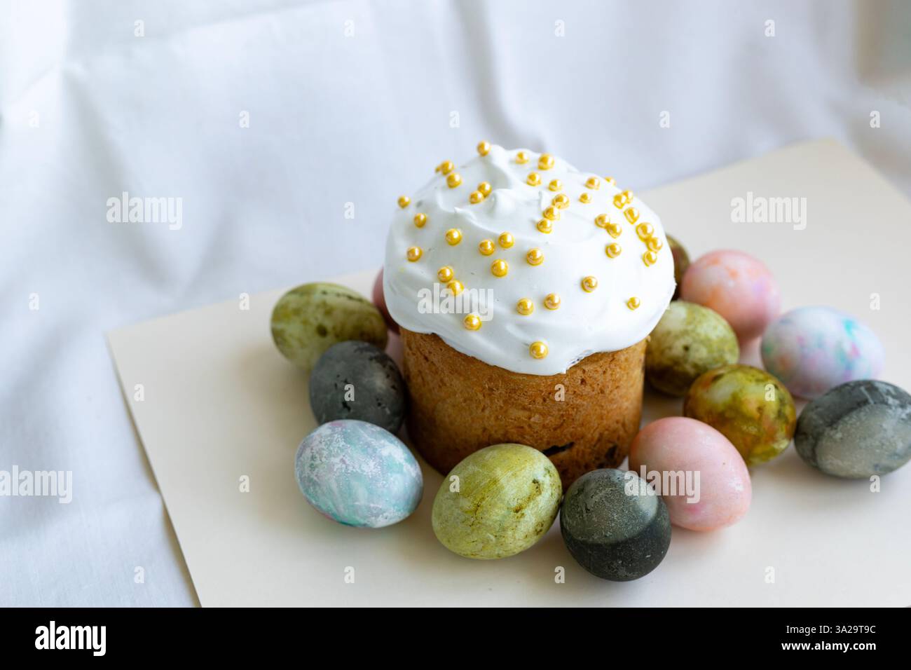 Easter cake with white icing and Easter eggs Stock Photo