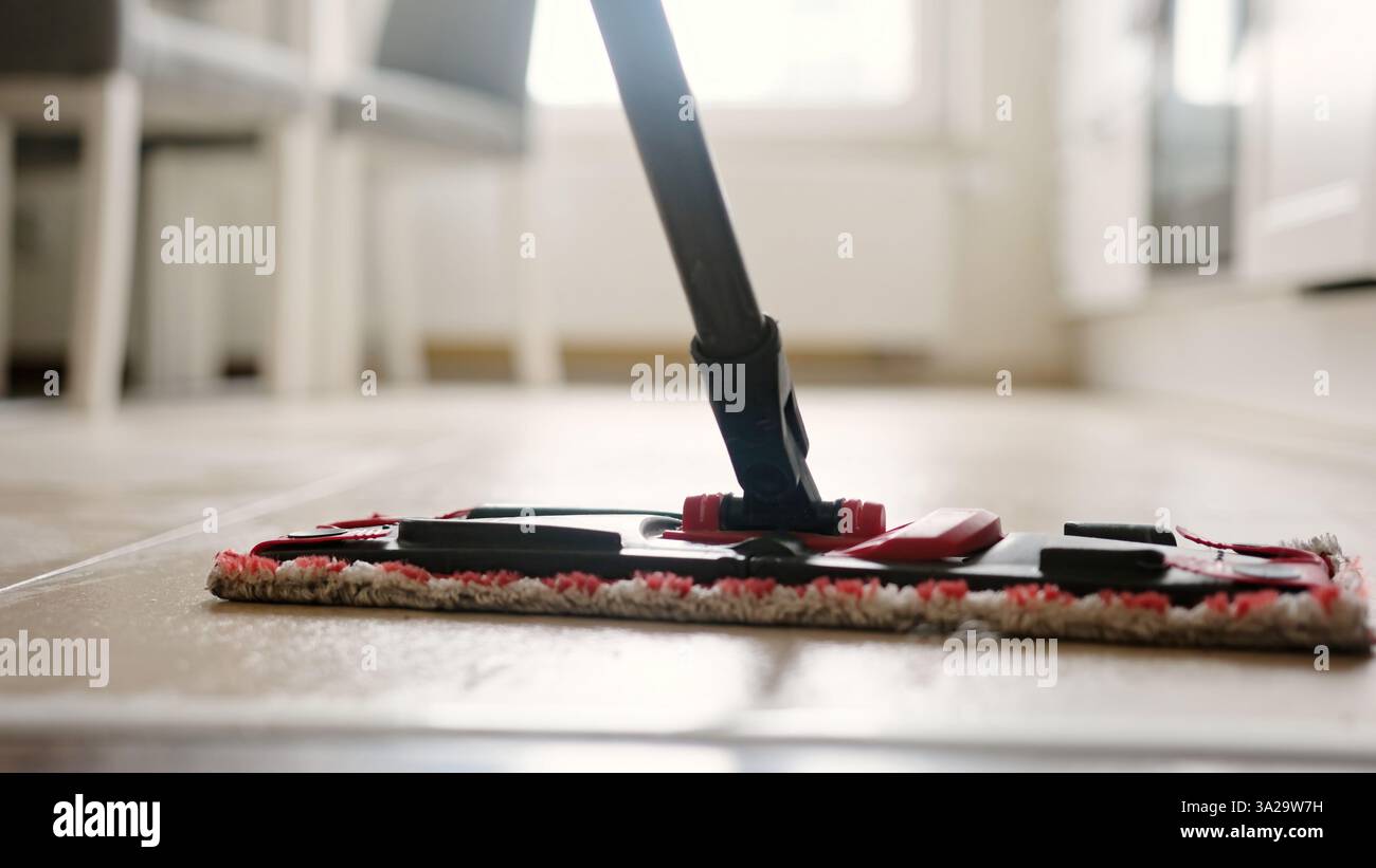 Mopping The Tiled Kitchen Floor Stock Photo