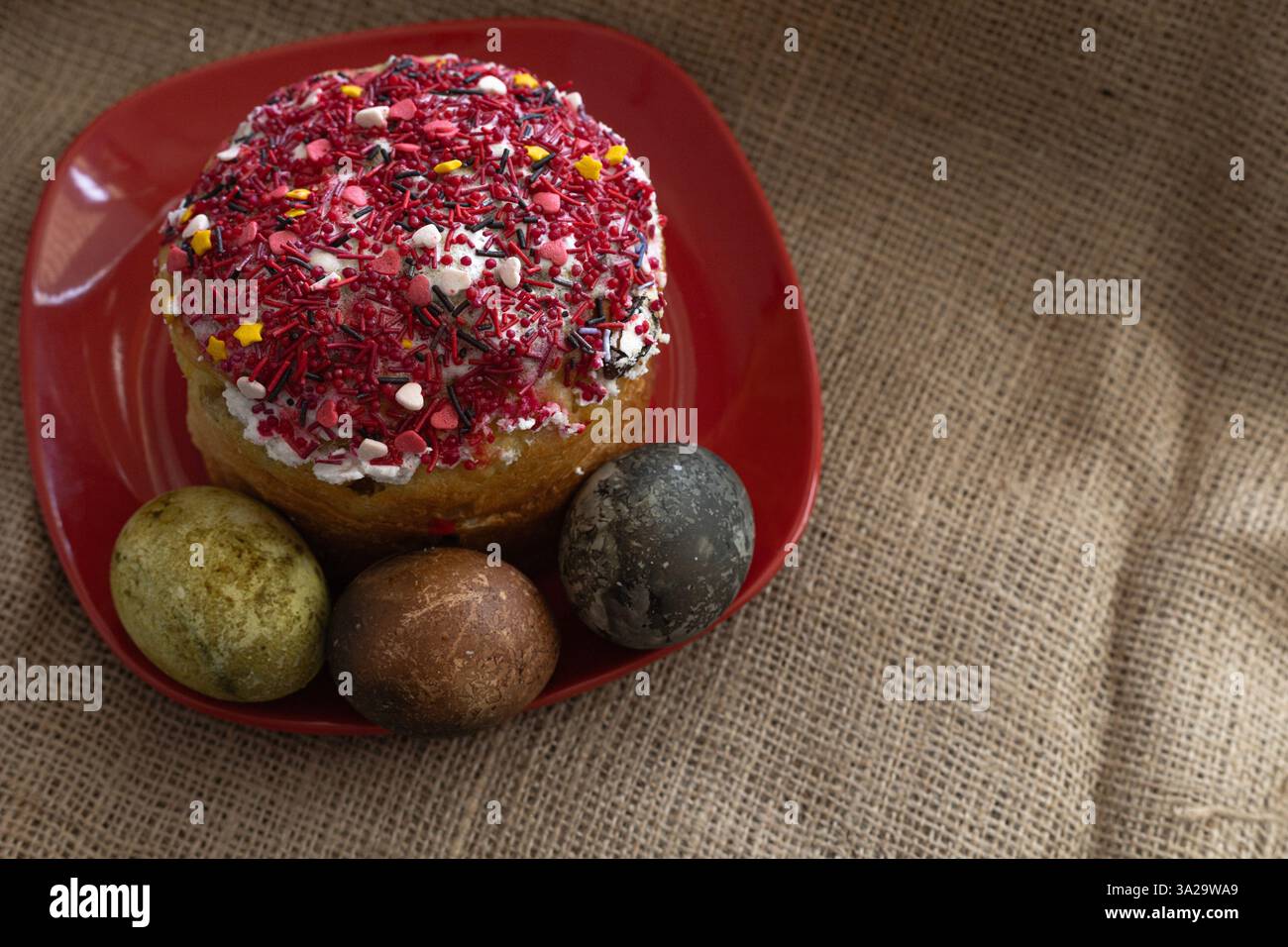 Easter cake and Easter eggs on a red plate Stock Photo