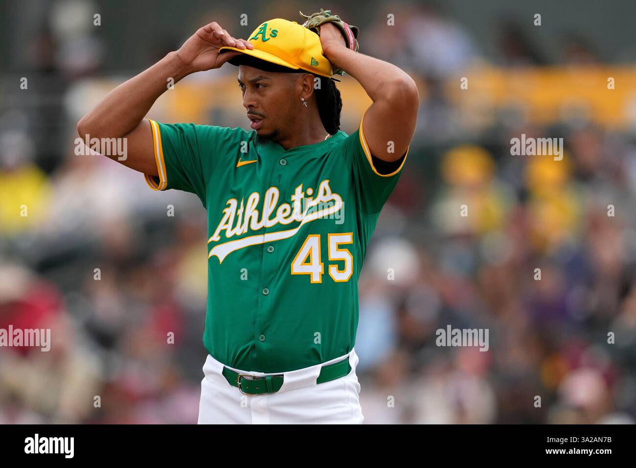 Athletics pitcher Osvaldo Bido adjusts his cap during the second inning of a spring training