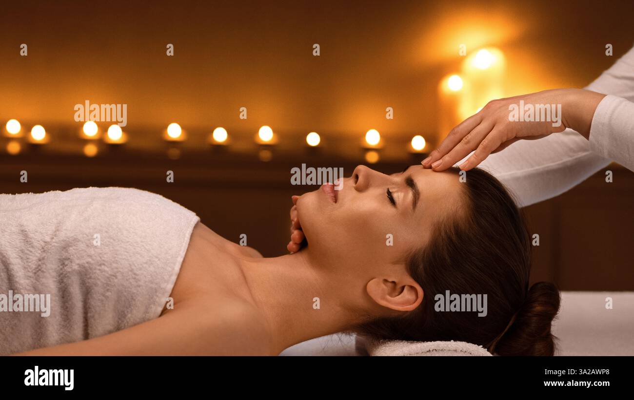 Spa therapist making relaxing acupressure massage for lady Stock Photo