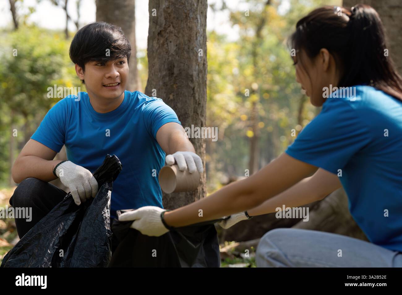 Team Collaboration and Environmental Care. A young man and woman ...