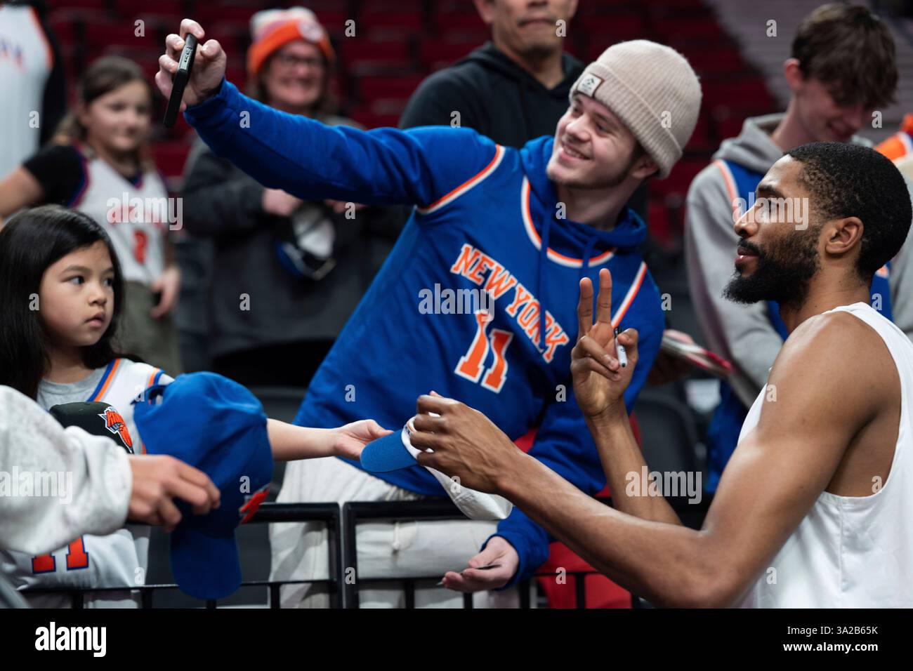 New York Knicks forward Mikal Bridges poses for a photo with fans ...