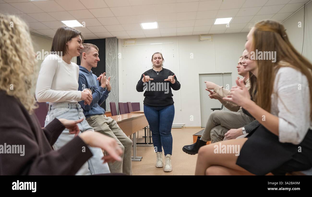 Young people communicate in sign language in a university classroom ...