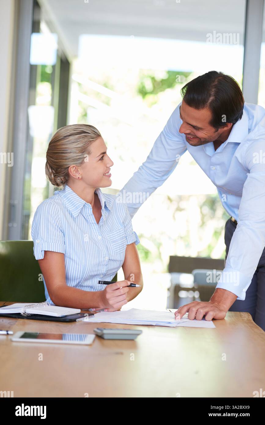Woman, man and documents with assistant, discussion and progress for budget, happy and financial review. Business people, entrepreneur and accountant Stock Photo
