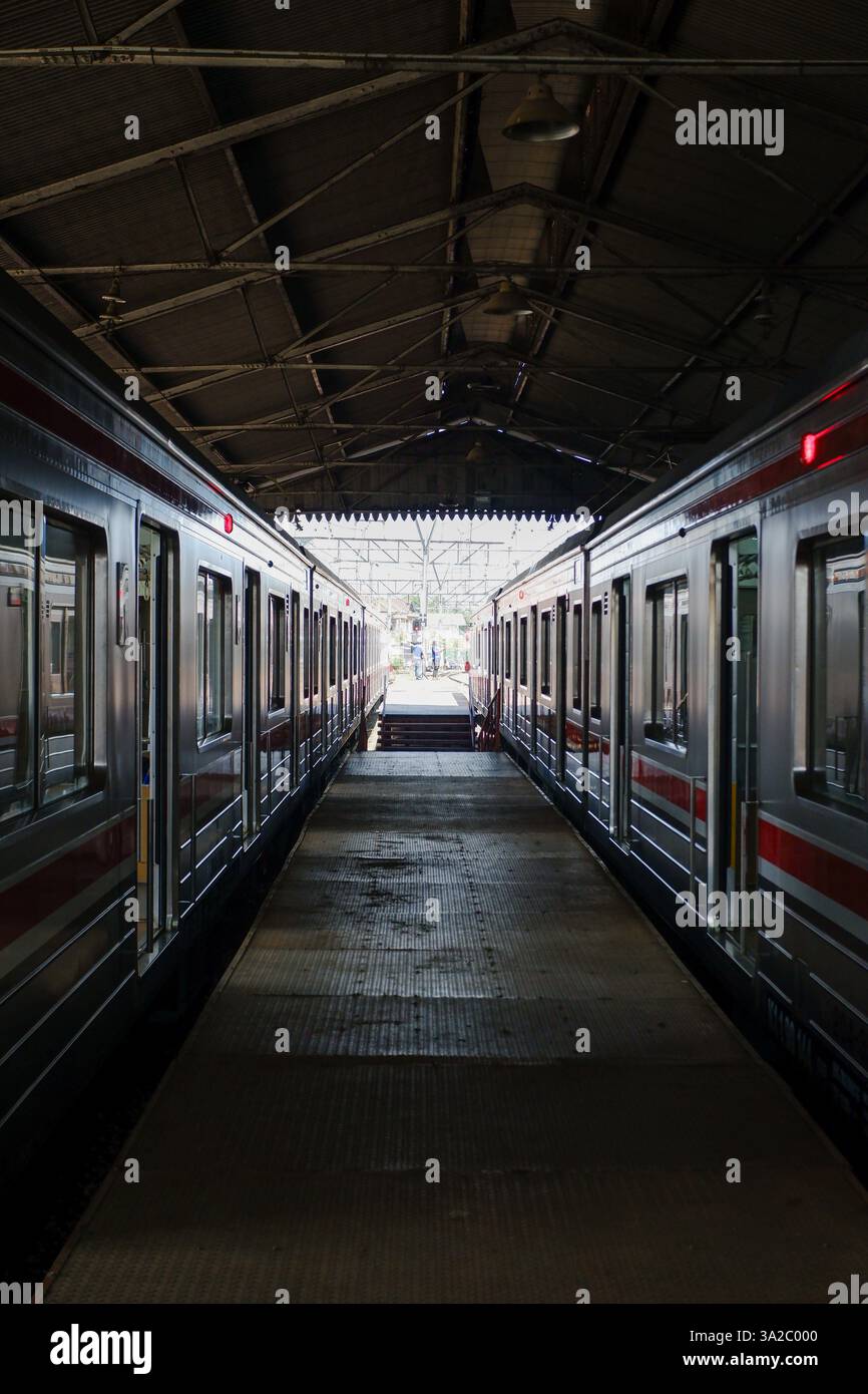 pedestrian path inside the station in the middle between two cars of a ...