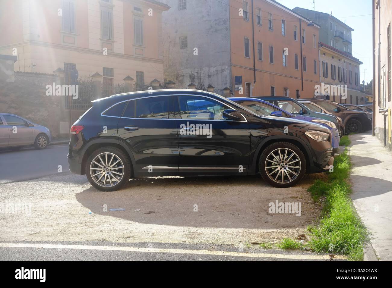 Lombardy, Italy March 1st 2025 Black Mercedes Benz GLA 200d 4MATIC parked sideways on gravel parking area near historic Cremona street Stock Photo