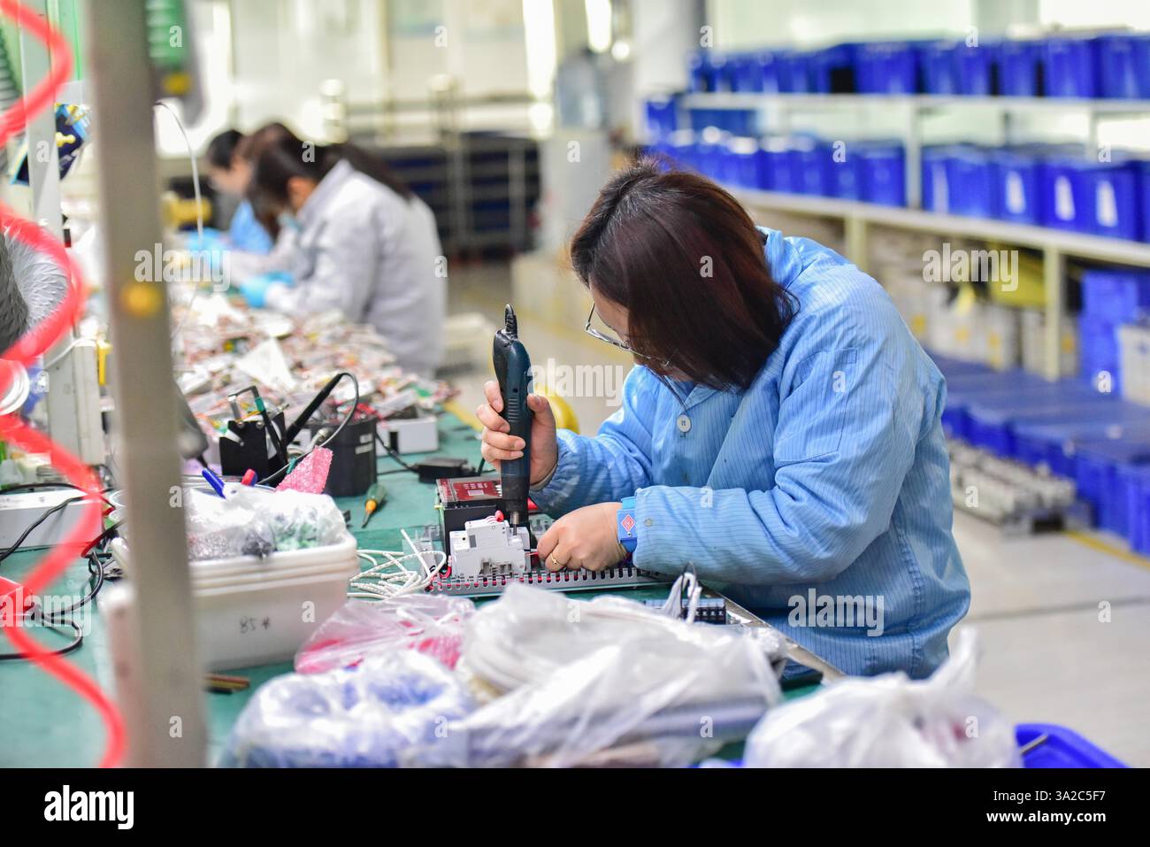 QINGZHOU, CHINA - MARCH 9, 2025 - Workers assemble smart water meters ...
