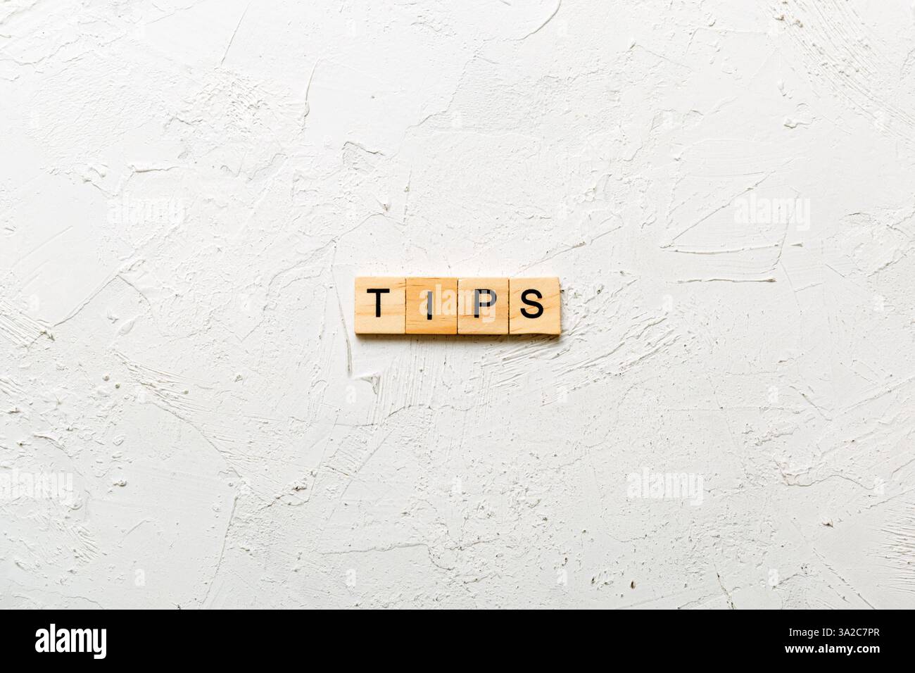 tips word written on wood block. tips text on table, concept. Stock Photo