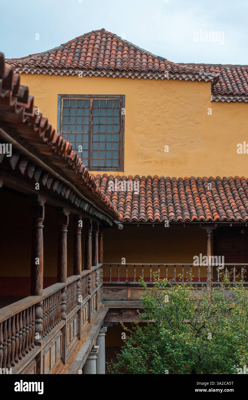 Traditional Spanish-style courtyard with wooden railings and terracotta ...