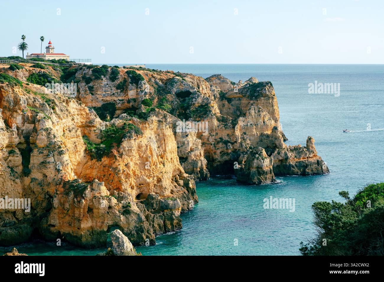 View of the Algarve coast around Ponta da Piedade in Lagos, Portugal including the iconic lighthouse Stock Photo