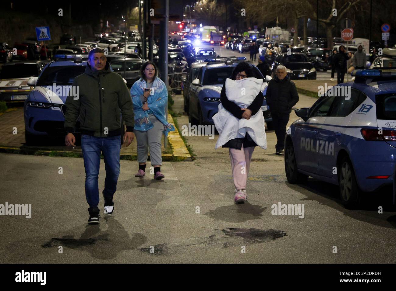 People seek safety in the streets following an earthquake north of Naples, Italy, Thursday