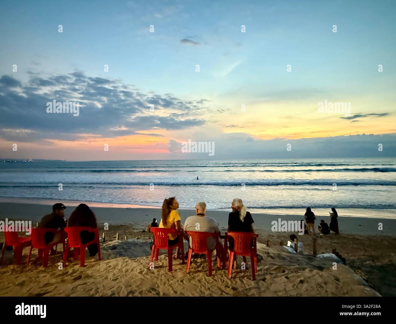 13 March 2025, Indonesia, Kuta Tourists watch the sunset on Bali