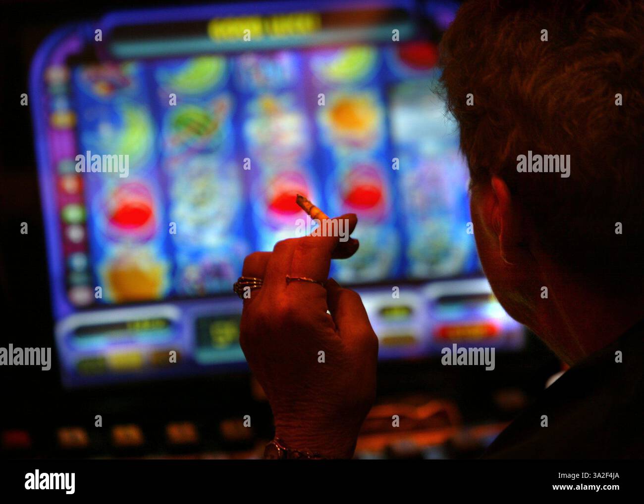 second not too small -- A cigarette burns as a gambler works the slot machine. Picture taken Friday, November 21, 2003 at the Thunder Valley Casino. (Credit: © Sacramento Bee/ZUMAPRESS.com) Stock Photo