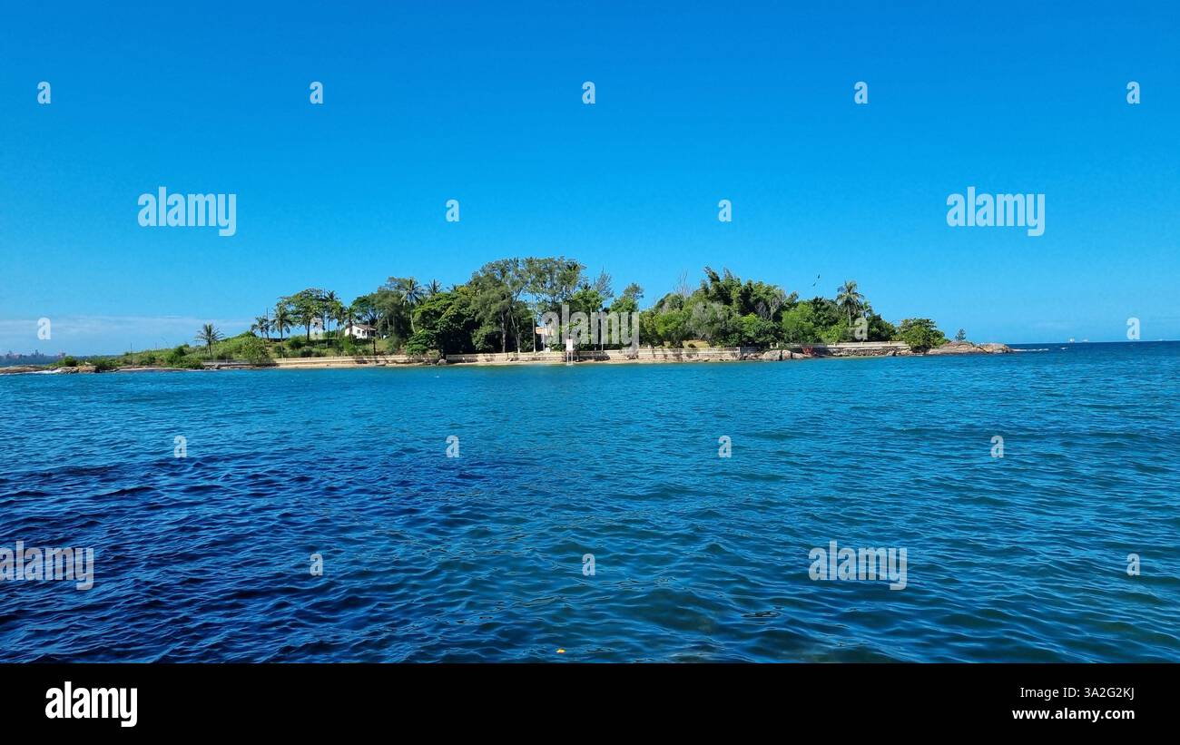 A serene island surrounded by the deep blue waters of the ocean - Smartphone Captured Stock Image