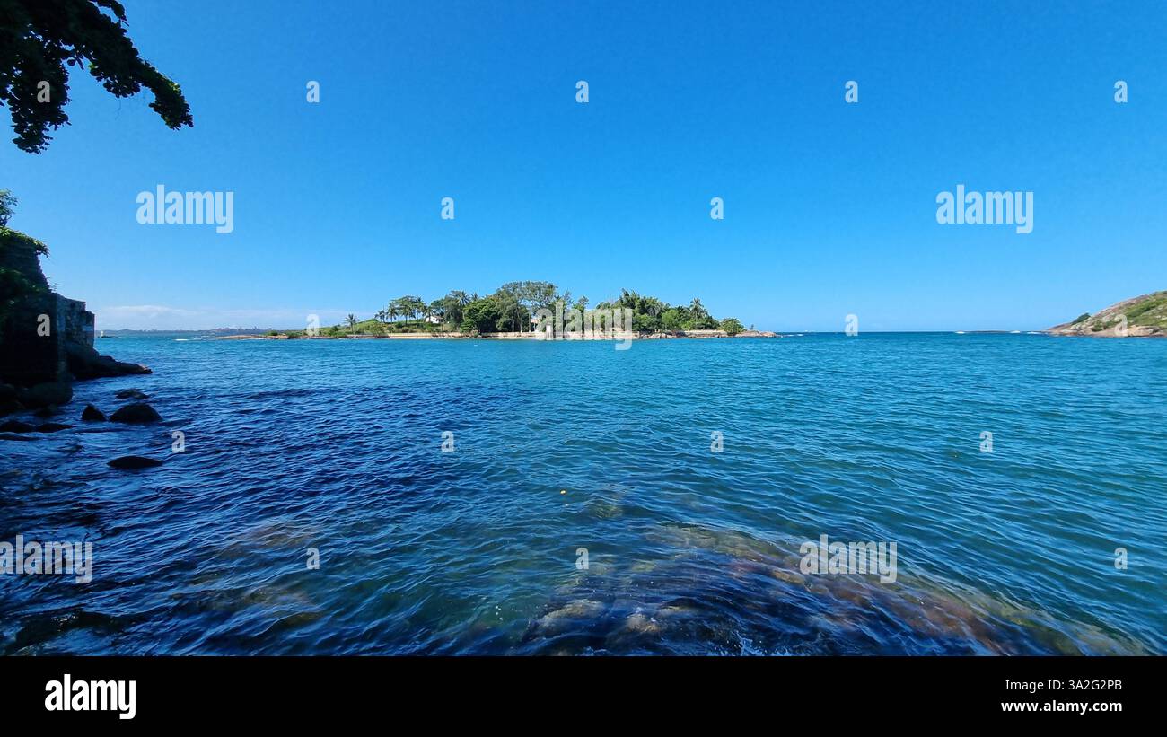 A serene island surrounded by the deep blue waters of the ocean - Smartphone Captured Stock Image