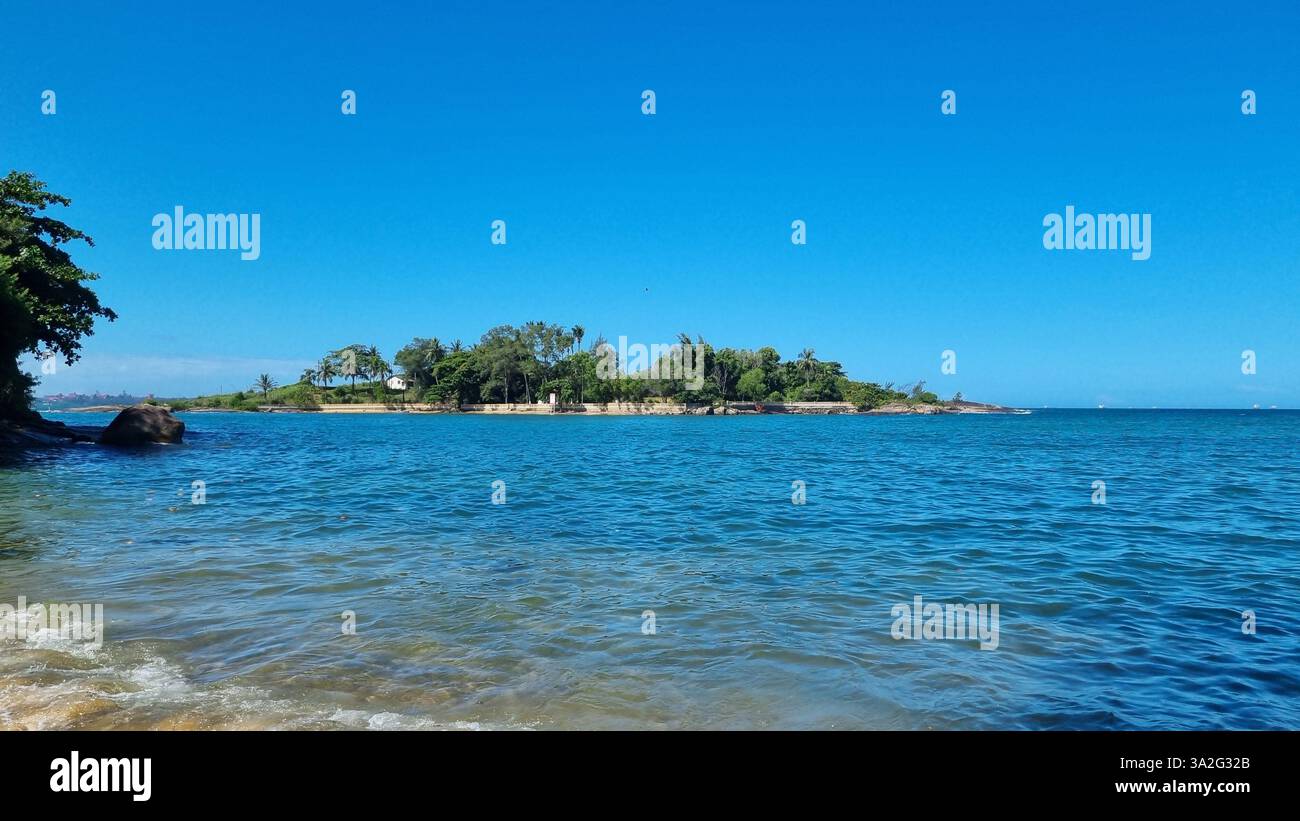 A serene island surrounded by the deep blue waters of the ocean - Smartphone Captured Stock Image