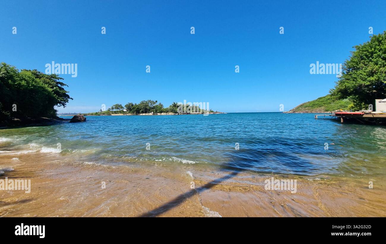 A serene island surrounded by the deep blue waters of the ocean - Smartphone Captured Stock Image