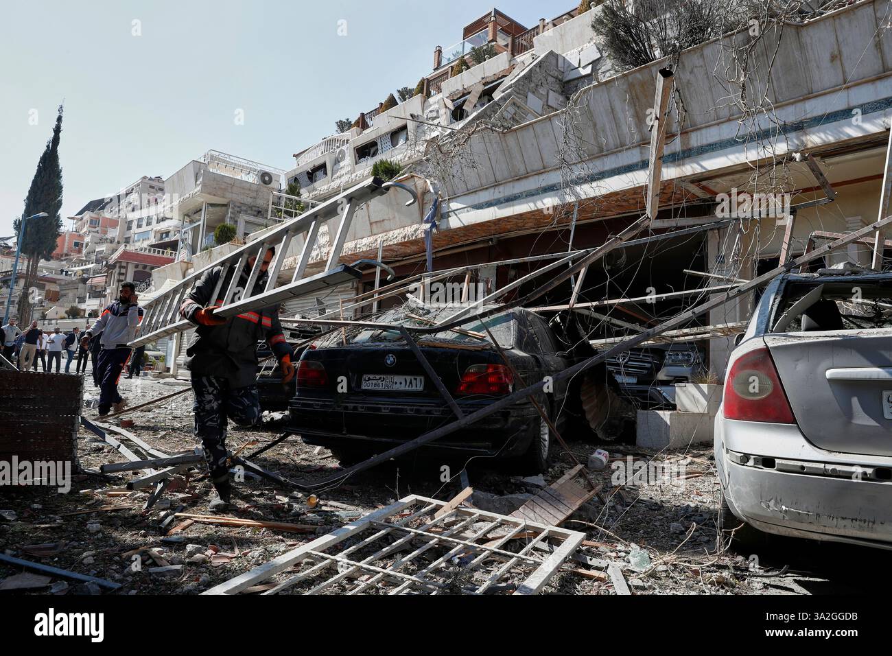 Firemen work at the site of an Israeli missile strike in Damascus