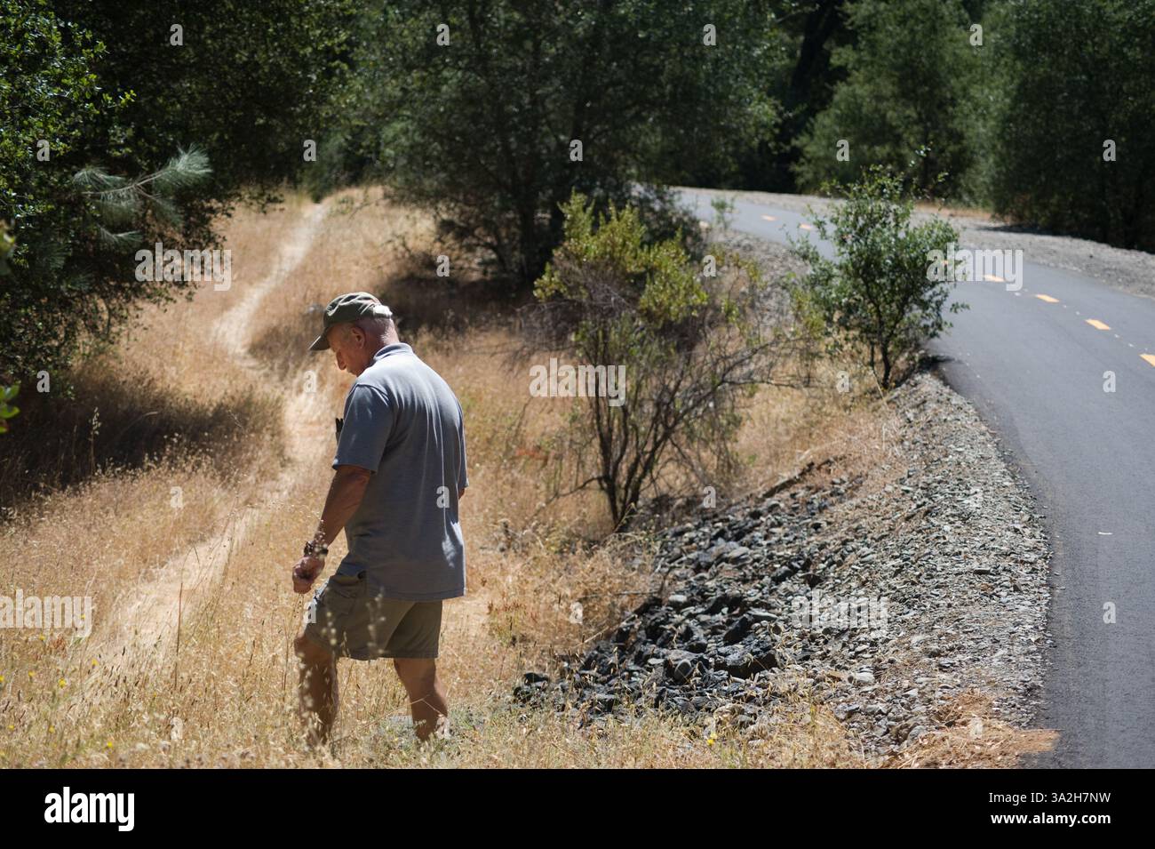 Bob Smart of Diamond Springs, a retired forest ranger, trails advocate and member of the El Dorado County Parks and Recreation Commission walks between the new trail and the old trail..Bob Smart takes a walk along a pedestrian and bicycle trail under construction on the former Southern Pacific right of way, south of Highway 50. This section the trail will incorporate the former railroad trestle over Weber Creek, linking Placerville with Missouri Flat Road and Diamond Springs. August 13, 2009. (Credit: © Sacramento Bee/ZUMAPRESS.com) Stock Photo