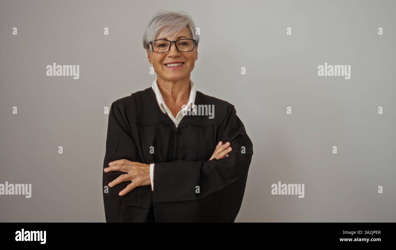 Woman Judge In Robe Grey-haired woman with glasses in a judge's robe standing with arms ...