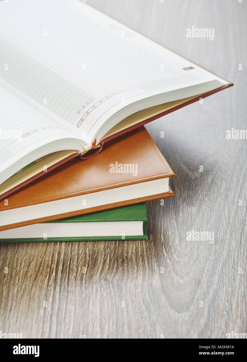 Three notebooks on wooden background Stock Photo