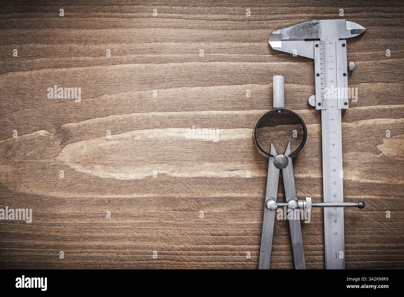 Slide caliper divider on wooden board copyspace construction concept Stock Photo