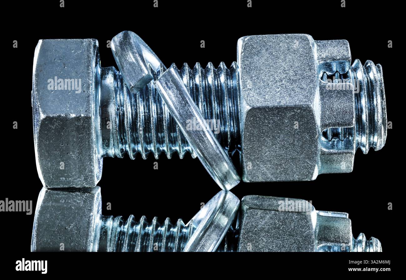 Stainless construction nut screwbolt spring washer on black surface Stock Photo