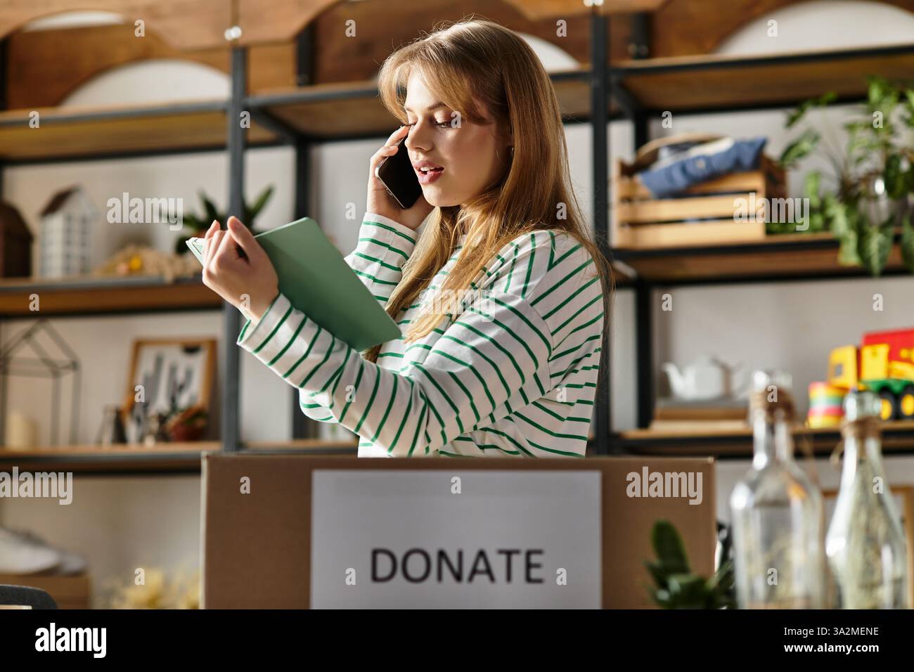 Sorting through her clothes, a young woman talks on the phone ...