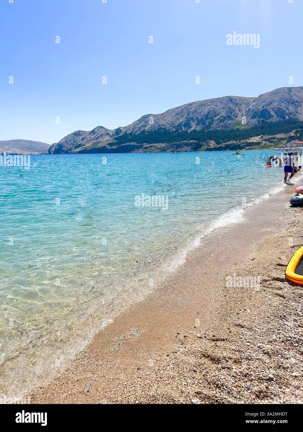 Baška Beach on Krk Island, Croatia, with its pristine pebbles and crystal-clear waters. A stunning coastal retreat surrounded by natural beauty. - Smartphone Captured Stock Image