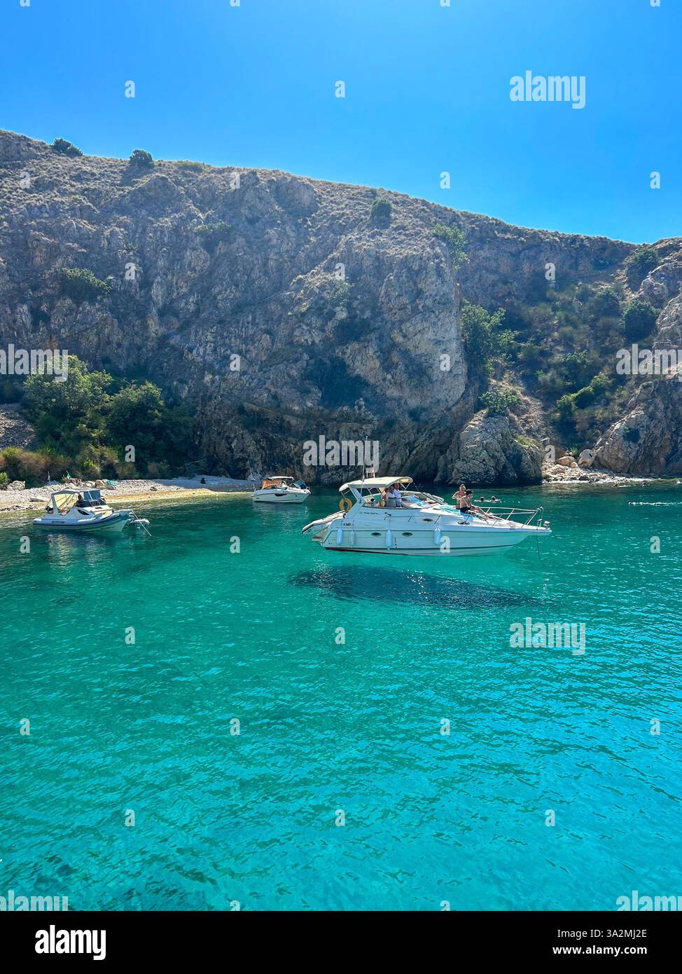 A boat gently floating on the calm waters near Krk Island, Croatia. A serene coastal scene with crystal-clear waters and the beauty of the Mediterrane - Smartphone Captured Stock Image